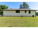 Spacious backyard featuring a lush green lawn and brick exterior of the home at 10116 Straphinge Trl, Covington, GA 30014
