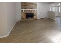Spacious living room featuring a stone fireplace, light wood floors, and ample natural light at 3512 Valley Chase Ct, Lithonia, GA 30038
