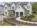 Elegant two-story home with manicured landscaping, stone accents, and welcoming walkway at 4775 Wyat Farm Overlook, Cumming, GA 30040