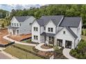 Stylish two-story home with dark roof, landscaped front yard, and inviting walkway at 4775 Wyat Farm Overlook, Cumming, GA 30040