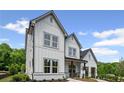 Beautiful two-story home showcasing board and batten siding and a charming front porch at 4775 Wyat Farm Overlook, Cumming, GA 30040