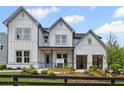 Beautiful modern farmhouse with white siding, dark roof, and professionally landscaped front yard at 4775 Wyat Farm Overlook, Cumming, GA 30040