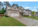 Attractive two-story house with beautiful landscaping, long driveway, and attached garage at 592 Eagles Nest Cir, Auburn, GA 30011
