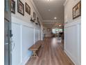 Inviting foyer with wood floors, bench seating, and a view into the open-concept living area at 592 Eagles Nest Cir, Auburn, GA 30011
