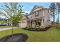 Lovely two-story home with manicured lawn, dark mulch flowerbeds, and a covered front porch at 592 Eagles Nest Cir, Auburn, GA 30011