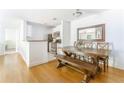 Bright dining area with a wooden table, bench seating, and a decorative mirror at 6204 Santa Fe Pkwy, Atlanta, GA 30350