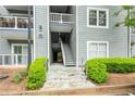 A close up of the exterior of the building with stairs leading to the upper floors and green shrubbery at 6204 Santa Fe Pkwy, Atlanta, GA 30350