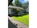 Inviting screened-in porch with views of the well-maintained lawn and mature trees at 167 Mathews Se Cir, Marietta, GA 30067