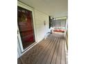 Cozy screened porch with a decorative wreath, bench, and wood flooring, offering a welcoming space at 167 Mathews Se Cir, Marietta, GA 30067