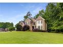 Attractive brick home with a well-maintained lawn and mature landscaping, enhancing its curb appeal at 2759 Thomashire Trce, Marietta, GA 30066