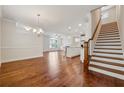 Spacious living area featuring hardwood floors and staircase leading to the upper level at 3182 Hartford Mill Pl, Duluth, GA 30097
