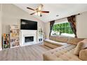Cozy living room boasts a fireplace, large windows, and built-in bookshelves, creating a comfortable and stylish atmosphere at 804 Rose Creek Walk, Woodstock, GA 30189