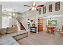 Bright and airy living room with vaulted ceiling, hardwood floors, and an open layout leading to the dining area and kitchen at 804 Rose Creek Walk, Woodstock, GA 30189