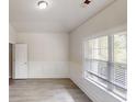 Bright bedroom featuring large windows with blinds, light wood floors, and white trim for a clean look at 900 Ellesmere Pt, Mcdonough, GA 30253