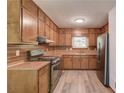 Functional kitchen featuring wood cabinets, stainless steel appliances, and ample counter space at 2584 Gravitt Rd, Duluth, GA 30096