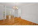 Elegant dining room with hardwood floors, classic chandelier and ample natural light at 3014 Volland Grove Trail, Lawrenceville, GA 30043