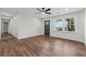 Bright, open-concept living room with wood flooring, a ceiling fan, and a large window offering plenty of natural light at 3757 Cindy Dr, Douglasville, GA 30135