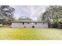 The back of the house features a well-maintained lawn and a clean, neutral exterior at 7125 Puckett Sw St, Covington, GA 30014