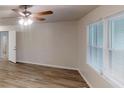 Bright living room featuring wood-look flooring and fresh white trim at 7125 Puckett Sw St, Covington, GA 30014
