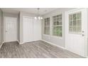 Dining area with modern flooring, closet, bright windows, and a door leading to the outside at 5229 Kirk Dr, Atlanta, GA 30349