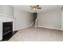 Bright living room features a classic fireplace, stairway, neutral walls, and carpet flooring at 5229 Kirk Dr, Atlanta, GA 30349