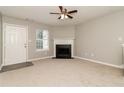 Cozy living room with fireplace, neutral walls, carpet flooring, and ceiling fan at 5229 Kirk Dr, Atlanta, GA 30349