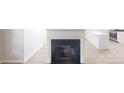 Living room fireplace with tile flooring and open view to kitchen with white countertops at 6614 Biscayne Blvd, Rex, GA 30273