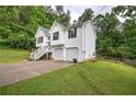 White two-story home with two car garage and green lawn at 70 Ashbury Ct, Dallas, GA 30157