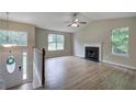 Open living room with wood-look floors, fireplace, and lots of light at 70 Ashbury Ct, Dallas, GA 30157