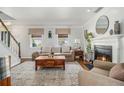 Bright living room features hardwood floors, a fireplace, and a comfortable seating area at 1175 Haven Brook Ne Way, Brookhaven, GA 30319