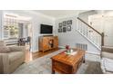 Inviting living room boasts hardwood floors, a decorative rug, and a staircase leading to the upper level at 1175 Haven Brook Ne Way, Brookhaven, GA 30319