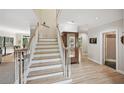 Bright foyer with hardwood floors, staircase, white trim and views to other rooms in the home at 1243 Williamswood Pointe, Decatur, GA 30033