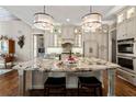 Spacious kitchen featuring a large center island, stainless steel appliances and gorgeous lighting at 341 Carl Sanders Dr, Acworth, GA 30101