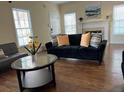 Comfortable living room featuring hardwood floors, neutral paint and large bright windows at 737 Cooper Sw St, Atlanta, GA 30315