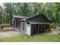 Rear exterior view of a home with gray siding and a covered storage area at 1341 Timbercrest Ct, Lawrenceville, GA 30045