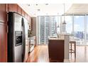 Modern kitchen with stainless steel appliances, granite countertops, and a breakfast bar overlooking the city at 855 Peachtree Ne St # 2203, Atlanta, GA 30308