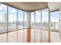 Bright living room featuring hardwood floors and floor-to-ceiling windows with panoramic city views at 855 Peachtree Ne St # 2203, Atlanta, GA 30308