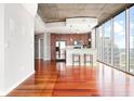 Open-concept living space with hardwood floors, modern kitchen, and floor-to-ceiling windows at 855 Peachtree Ne St # 2203, Atlanta, GA 30308