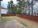 Spacious backyard featuring a wooden fence, offering privacy and a secure area for outdoor activities at 2289 Overlook Ave, Lithonia, GA 30058