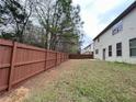 Large fenced-in backyard, perfect for pets and recreation, with ample space and views of the home's exterior at 2289 Overlook Ave, Lithonia, GA 30058