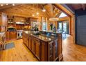 Spacious kitchen with wooden cabinetry, granite countertops, and stainless steel appliances at 4095 E Highway 166 Hwy, Carrollton, GA 30116
