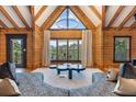 Living room with wood walls, a vaulted ceiling, and a large window with natural light at 4095 E Highway 166 Hwy, Carrollton, GA 30116