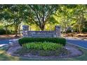 Stone community sign with lush landscaping welcomes residents to Burnt Hickory Registry at 4842 Registry Nw Dr, Kennesaw, GA 30152