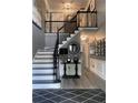 Elegant foyer features a staircase with black iron railings and decorative accents at 910 Kings Arms Way, Alpharetta, GA 30022