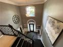 Grand foyer with high ceilings, chandelier, large clock, and beautiful front door at 910 Kings Arms Way, Alpharetta, GA 30022