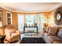 Cozy living room with hardwood floors, large windows, comfortable seating, and stylish decor at 910 Kings Arms Way, Alpharetta, GA 30022