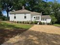 A white home has a driveway and freshly manicured yard at 95 Whitlock Sw Ave, Marietta, GA 30064