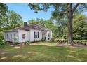 Well-maintained home with lush green lawn and mature trees at 95 Whitlock Sw Ave, Marietta, GA 30064