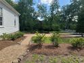 A gravel pathway lined with plants leads to the backyard of a beautiful home at 95 Whitlock Sw Ave, Marietta, GA 30064