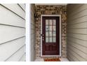 Close-up of a welcoming front door with sidelights and brick surround at 1212 Lake Point Way, Suwanee, GA 30024